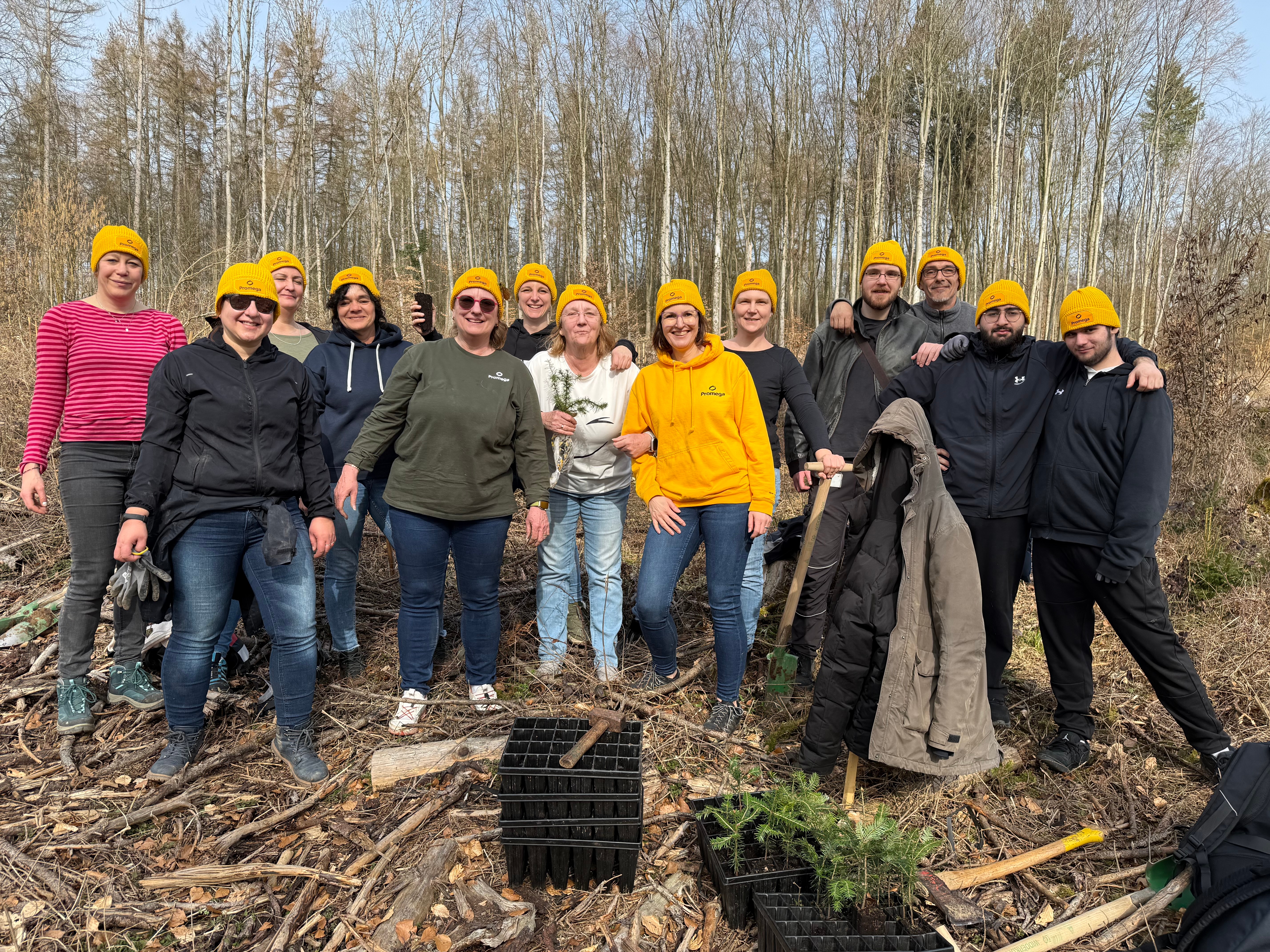 Promega employees in a group photo after planting trees
